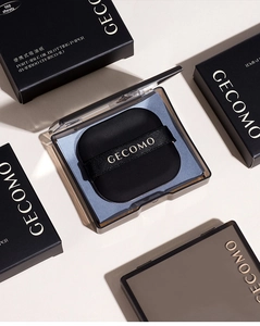Macro view of portable bamboo charcoal oil blotting paper kit with puff and mirror