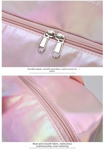 Detail of pink iridescent travel bag featuring smooth dual metal zippers and precise stitching