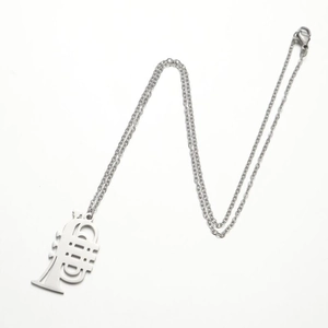 Polished stainless steel trumpet pendant necklace on a delicate silver cross chain
