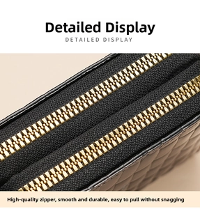 Macro shot of dual gold zippers and quilted leather detail on a large capacity wallet