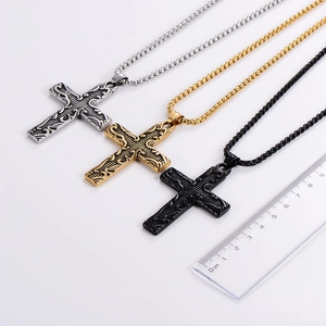Detailed size comparison of vintage relief cross pendants in silver gold and black steel