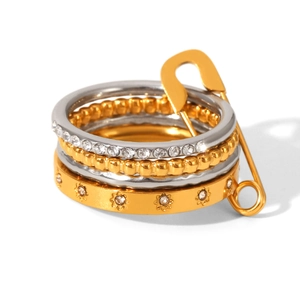 Stacked set of gold and silver stainless steel rings with zircon accents and star motifs