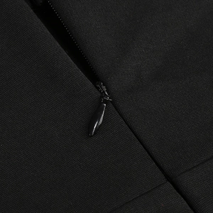Detailed close-up of a seamless invisible zipper on a slim fit black maxi party dress