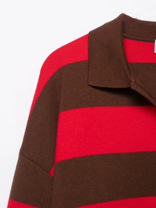 Close-up of the polo collar and shoulder on a red and brown striped knit sweater