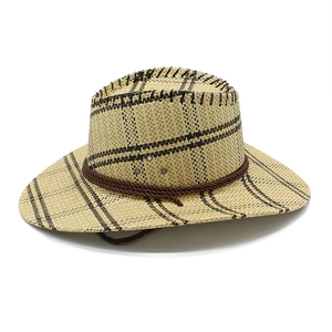 Detail of western straw hat featuring woven grid texture and brown braided cord trim