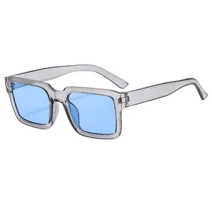 Modern square sunglasses with translucent grey frames and blue tinted lenses