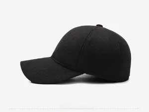 Detail view of winter baseball cap featuring wool blend fabric and side metal tag