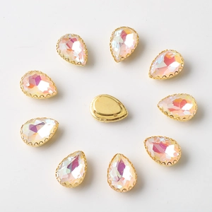 Macro detail of teardrop rhinestones with AB crystals and golden metal claw settings
