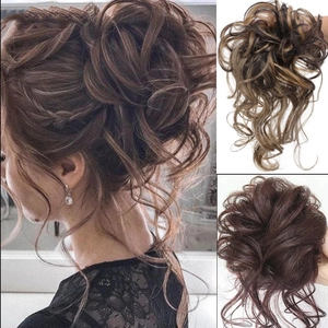 Close-up of curly hair bun extension in brown and dark brown highlights for natural look