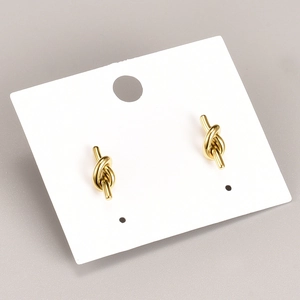 Minimalist 18K gold plated titanium knot stud earrings on a white display card