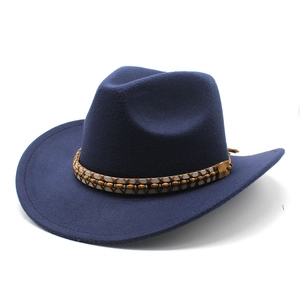 Close-up of dark blue wool felt cowboy hat with woven band and decorative wooden beads