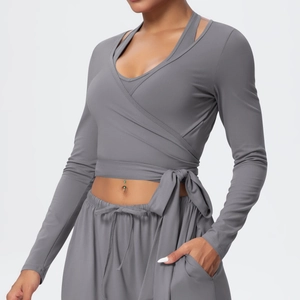 Detail of grey wrap yoga top featuring side tie closure and high-elasticity fabric