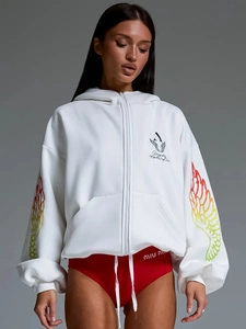 Detail of white oversized hoodie showing vibrant rainbow wing prints and zipper design