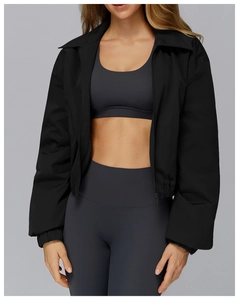 Detail of a women's black windproof zip-up jacket and grey high-waist yoga sports set