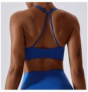 Detail of royal blue sports bra with thin cross-back straps and high-elastic fabric