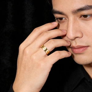 Polished 18K gold titanium steel double band ring for men on a dark background