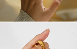 Detail of gold-plated ring set featuring vertical stripes and micro-bead textures