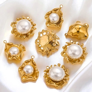 Golden stainless steel sun flower pearl pendants on white silk background for DIY jewelry