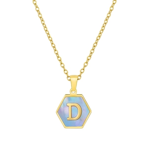 Macro shot of 18K gold hexagonal pendant with blue shell inlay and letter D engraving