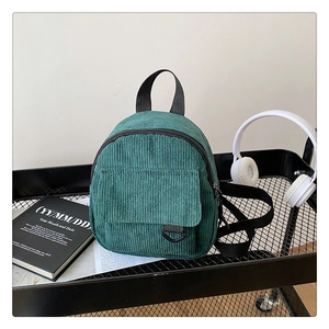Close-up of vintage green corduroy backpack with D-ring pocket and top handle