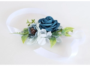 Close-up of blue rose bridal wrist corsage with silk petals and satin ribbon tie