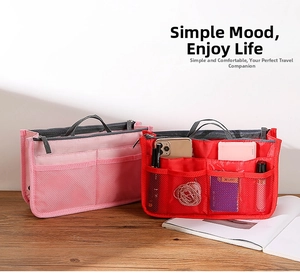 Detail of pink and red felt tote organizers with mesh pockets on a wooden desk