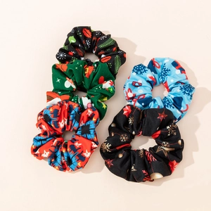 Close-up of four Christmas scrunchies with snowman, bell and reindeer festive patterns