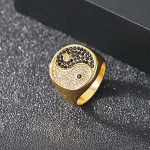 Macro shot of gold-plated square signet ring featuring a black and white diamond Tai Chi icon