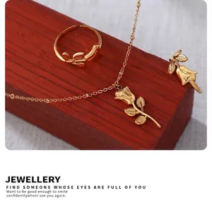 Vue détaillée d'un collier pendentif rose dorée et bague feuille sur base rouge