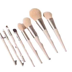 Morandi 8-piece makeup brush set with pink bristles and beige handles on white background