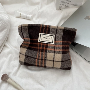 Vintage wool plaid cosmetic bag with 'Pleasant Time' patch on a white fabric surface