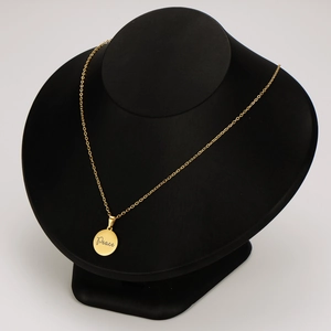 18K gold plated stainless steel necklace with round Peace engraved pendant on model