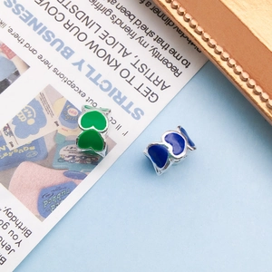 Detail of emerald green and royal blue enamel heart beads for DIY jewelry making