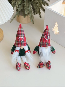 Pair of festive Christmas gnomes in red plaid hats placed in a cozy home decor setting
