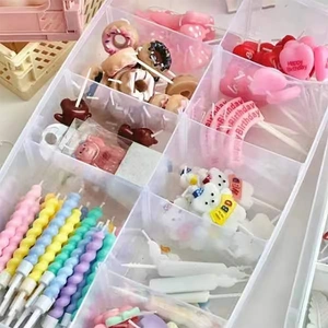 Assorted colorful creative cartoon heart and star birthday candles in a clear storage box