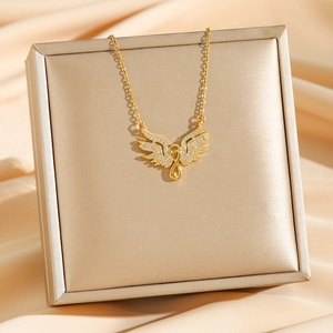 Golden angel wing necklace with white rhinestones on silk satin and jewelry box display