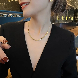 Golden square link chain necklace and earrings set worn by a fashion model