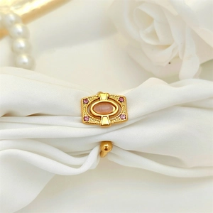Detailed macro view of vintage gold ring with pink opal inlay on luxury white silk