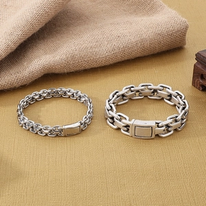 Detail view of vintage interlocking stainless steel chain bracelets with square clasps
