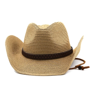 Detail of woven straw cowboy hat featuring brown leather band and adjustable chin strap