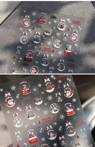 Detailed macro view of 3D embossed Christmas nail stickers featuring Santa and snowflakes