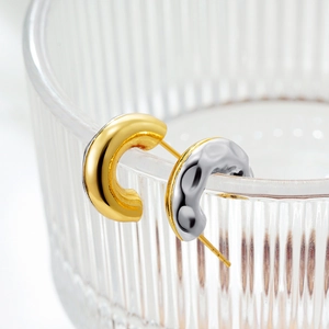 French vintage C-shaped gold and silver earrings with hammered texture on glass rim