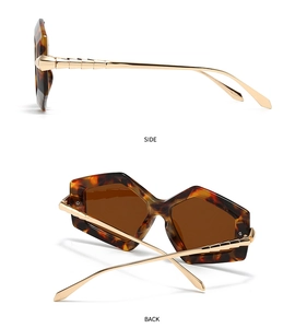 Detail of tortoise frame and gold bamboo textured metal temples on oversized sunglasses