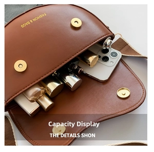 Capacity display of the brown saddle bag showing smartphone and makeup storage