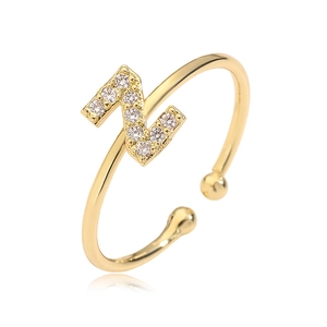 Close-up of golden letter Z ring featuring zircon inlay and adjustable open band design