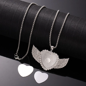 Macro detail of sublimation angel wing heart pendant with rhinestones on a snake chain