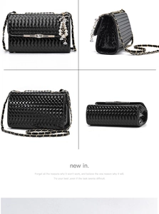 Detail view of black woven crossbody bag with gold chain strap and pearl crystal charm
