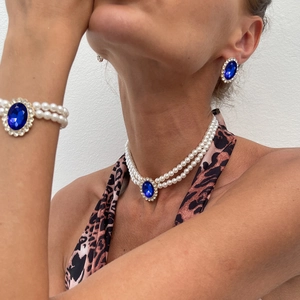 Detail of vintage 3-piece set with blue gems, pearls and rhinestones on a model