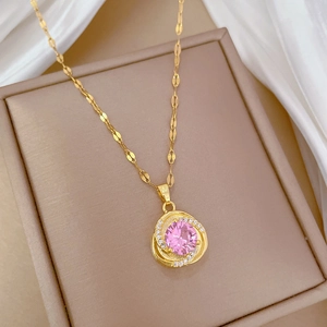 Macro shot of a luxury gold necklace featuring a round pink zircon in a jewelry box