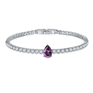 Macro view of silver tennis bracelet with round zircons and pear-shaped purple stone